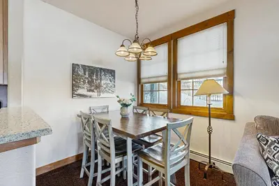 a kitchen and dining room with a table and chairs at Bluebird Skies in Granby