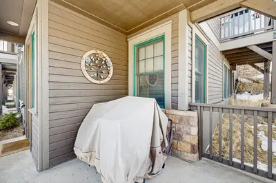 a porch of a house with a table on it at Bluebird Skies in Granby
