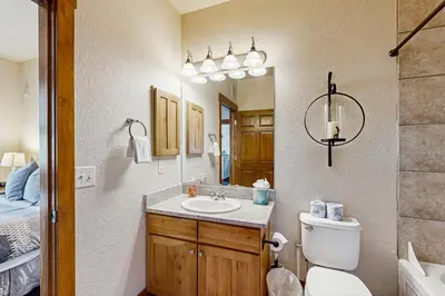 a bathroom with a sink and a toilet and a mirror at Bluebird Skies in Granby