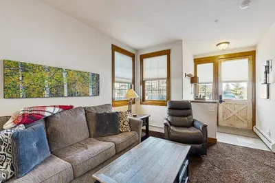 a living room with a couch and a chair at Bluebird Skies in Granby