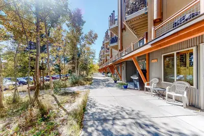 a sidewalk in front of a building with chairs at Wildernest Getaway in Silverthorne