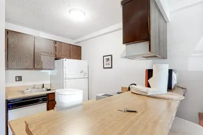 a kitchen with a wooden counter top and a white refrigerator at Wildernest Getaway in Silverthorne