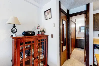a room with a wooden cabinet with a lamp on it at Wildernest Getaway in Silverthorne