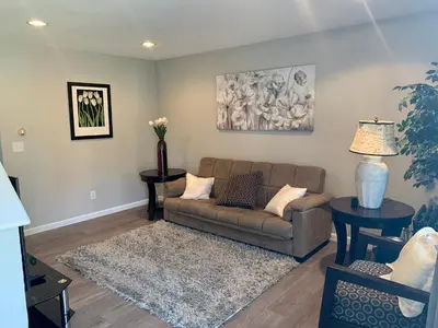 a living room with a couch and two tables at Your home close to Anshutz and DIA in Aurora