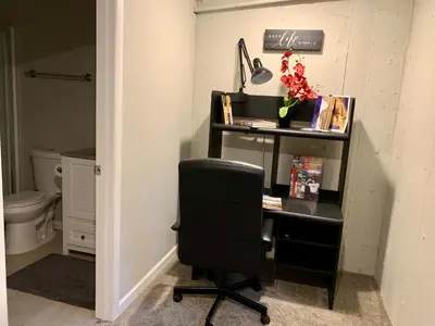 a desk with a chair in a room with a toilet at Your home close to Anshutz and DIA in Aurora