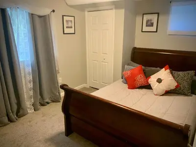 a bedroom with a bed with red and white pillows at Your home close to Anshutz and DIA in Aurora