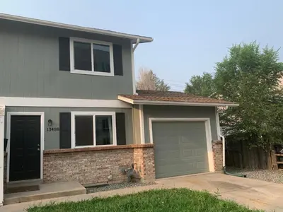 a gray house with a garage at Your home close to Anshutz and DIA in Aurora