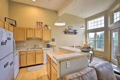 a kitchen with wooden cabinets and a white refrigerator at Silverthorne Gem with Community Perks 11 Mi to Ski! in Silverthorne