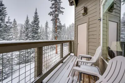 two chairs on a porch with snow covered trees at Silverthorne Gem with Community Perks 11 Mi to Ski! in Silverthorne