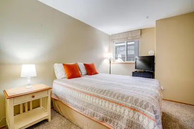a small bedroom with a bed and a television at Silverthorne Gem with Community Perks 11 Mi to Ski! in Silverthorne