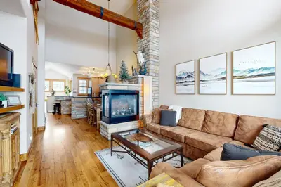 a living room with a couch and a fireplace at Granby Grandeur in Granby