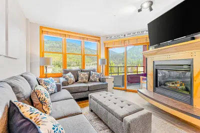a living room with a couch and a fireplace at Silvermill Lodge 8250 in Keystone