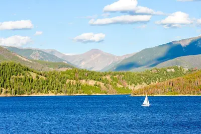 a sailboat in the middle of a large blue lake at Silvermill Lodge 8250 in Keystone