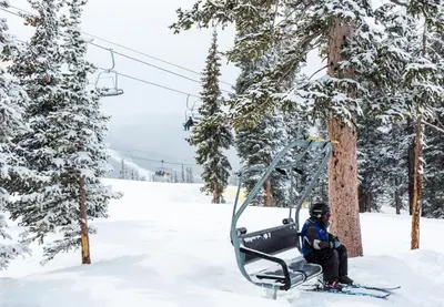 a person sitting on a ski lift in the snow at Silvermill Lodge 8250 in Keystone