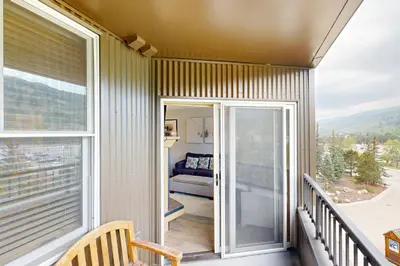 a balcony with a view of a living room at Silvermill Lodge 8250 in Keystone
