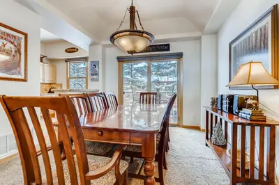 a dining room with a wooden table and chairs at Premiere 2Br Townhome - Shuttle to Slopes, Kids Ski Free! condo in Keystone
