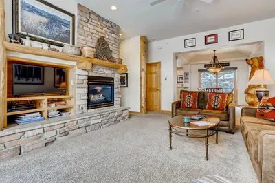 a living room with a couch and a fireplace at Premiere 2Br Townhome - Shuttle to Slopes, Kids Ski Free! condo in Keystone