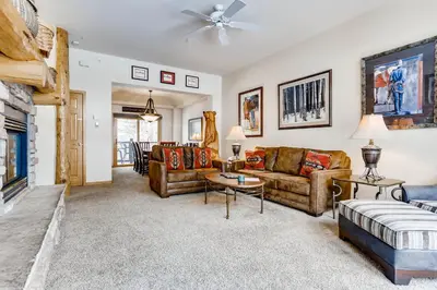 a living room with couches and a fireplace at Premiere 2Br Townhome - Shuttle to Slopes, Kids Ski Free! condo in Keystone