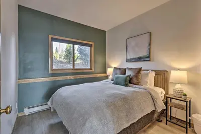 a bedroom with a large bed and a window at Pool, Hot Tub and Ski Shuttle! Silverthorne Condo in Silverthorne