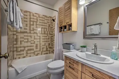 a bathroom with a sink and a tub and a toilet at Pool, Hot Tub and Ski Shuttle! Silverthorne Condo in Silverthorne