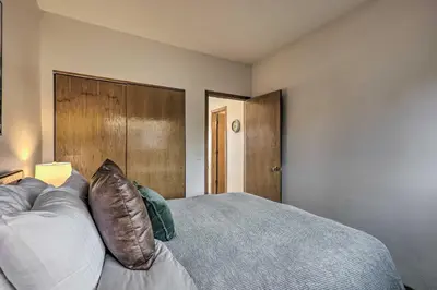 a bedroom with a bed and a wooden headboard at Pool, Hot Tub and Ski Shuttle! Silverthorne Condo in Silverthorne