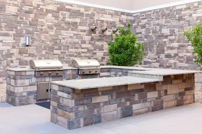 a outdoor kitchen with a brick wall at Hilton Garden Inn Broomfield Boulder in Broomfield