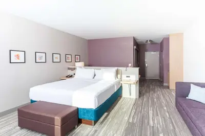 a hotel room with a bed and a couch at Hilton Garden Inn Broomfield Boulder in Broomfield