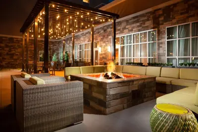 a living room with a fire pit in the middle at Hilton Garden Inn Broomfield Boulder in Broomfield
