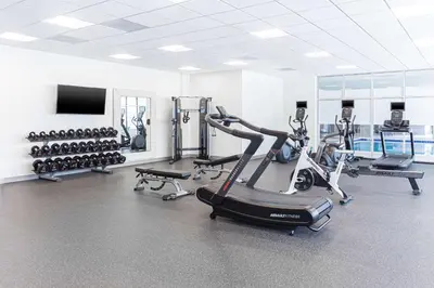 a gym with several treadmills and cardio machines at Homewood Suites By Hilton Broomfield Boulder in Broomfield