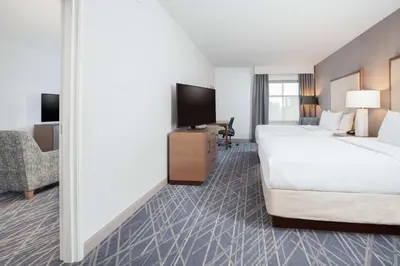 a hotel room with a large bed and a desk at Homewood Suites By Hilton Broomfield Boulder in Broomfield