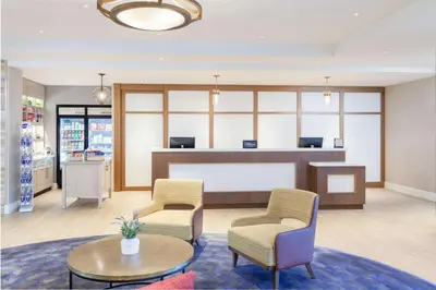 a waiting room with two chairs and a table at Homewood Suites By Hilton Broomfield Boulder in Broomfield