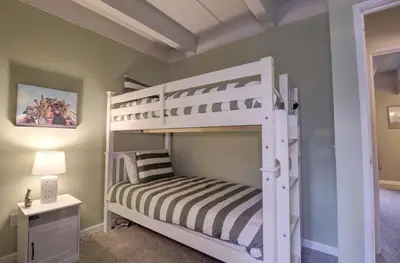 a white bunk bed in a room with a lamp at B207 Ten Mile Island 2Br 2Ba condo in Frisco