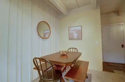 a dining room with a table and chairs and a mirror at B207 Ten Mile Island 2Br 2Ba condo in Frisco