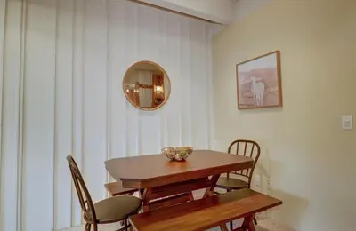 a dining room with a table and chairs and a mirror at B207 Ten Mile Island 2Br 2Ba condo in Frisco