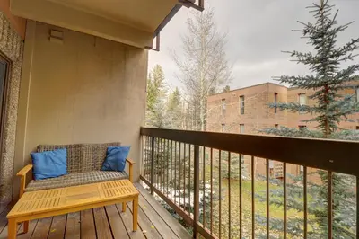 a balcony with a bench and a tree at B207 Ten Mile Island 2Br 2Ba condo in Frisco