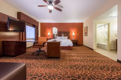 a hotel room with a bed and a desk at Hampton Inn & Suites Boulder North in Boulder