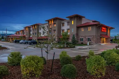 a row of apartment buildings in a parking lot at Hampton Inn & Suites Boulder North in Boulder