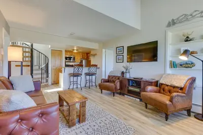 a living room with a couch and a table at Ski-InandOut Granby Condo with Mtn Views and Balcony! in Granby