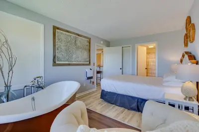 a hotel room with a tub and a bed at Ski-InandOut Granby Condo with Mtn Views and Balcony! in Granby