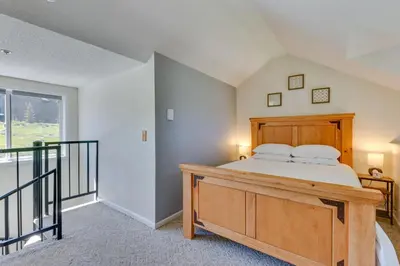 a bedroom with a bed and a balcony at Ski-InandOut Granby Condo with Mtn Views and Balcony! in Granby