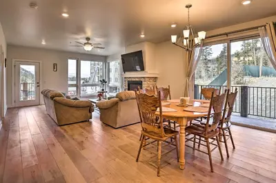 a dining room and living room with a table and chairs at 1 Mi to Ski Slopes! Mtn-View Condo in Keystone in Keystone
