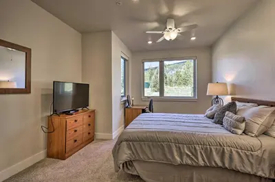 a bedroom with a bed and a flat screen tv at 1 Mi to Ski Slopes! Mtn-View Condo in Keystone in Keystone