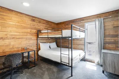a bedroom with a bunk bed and a desk and a chair at Mountain Views & Meadows in Silverthorne
