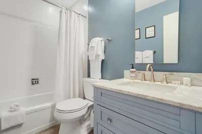 a bathroom with a white toilet and a sink at Mountain Views & Meadows in Silverthorne
