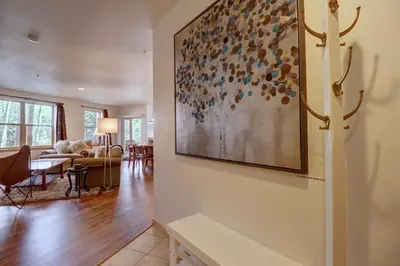 a living room with a large painting on the wall at 101 Streamside Lane condo in Frisco