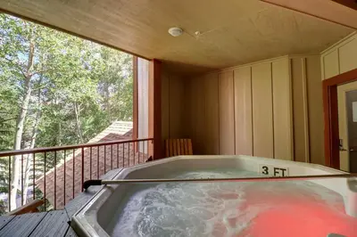 a hot tub on a balcony with a clock on it at 101 Streamside Lane condo in Frisco
