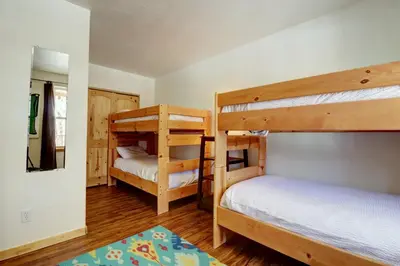 a bedroom with two bunk beds and a rug at 101 Streamside Lane condo in Frisco