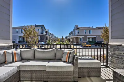 a patio with a couch on a balcony at Near Hiking and Biking Trails Townhome with Patio in Aurora
