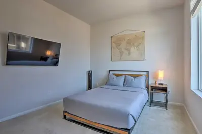 a white bedroom with a bed and a tv at Near Hiking and Biking Trails Townhome with Patio in Aurora