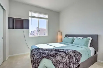 a bedroom with a large bed with a window at Near Hiking and Biking Trails Townhome with Patio in Aurora